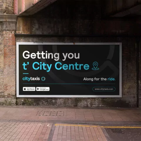 City Taxis billboard under a train bridge