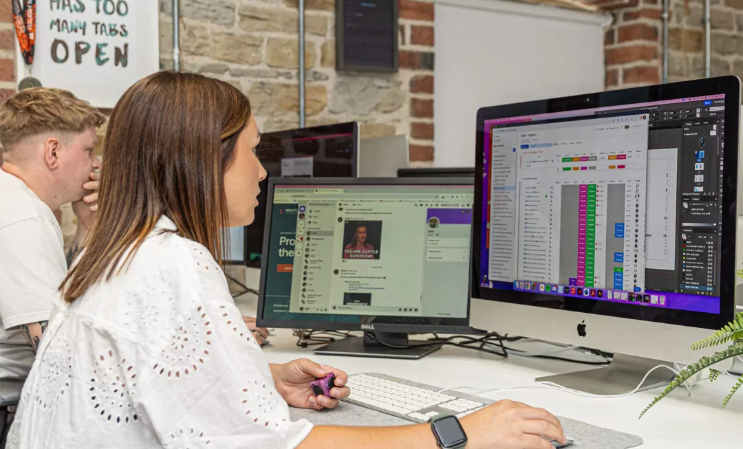 Will Taylor and Sophie Hardwick working on multiple computer screens