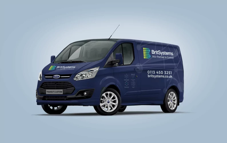 A dark-blue Ford Transit Custom van, displaying BritSystems branding and contact details, sits on a light-blue background.