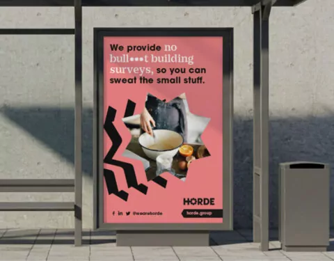 A large pink poster for Horde appears on a bus stop. the text on the poster reads 'we provide no bull**t building surverys, so you can sweat the small stuff.