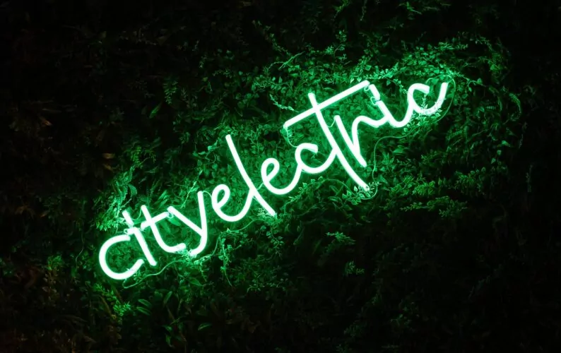 A green neon sign, spelling 