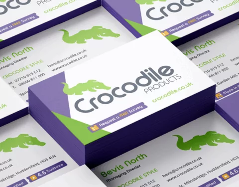 A stack of business cards displays a crocodile logo, contact information for Bevis North, Managing Director, and the company name Crocodile Products.