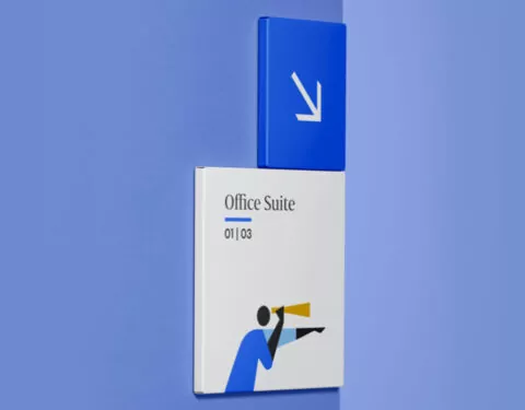 A white sign indicates “Office Suite 01|03”, featuring an illustrated person using a telescope; a blue arrow sign points down, affixed to a pale blue wall.
