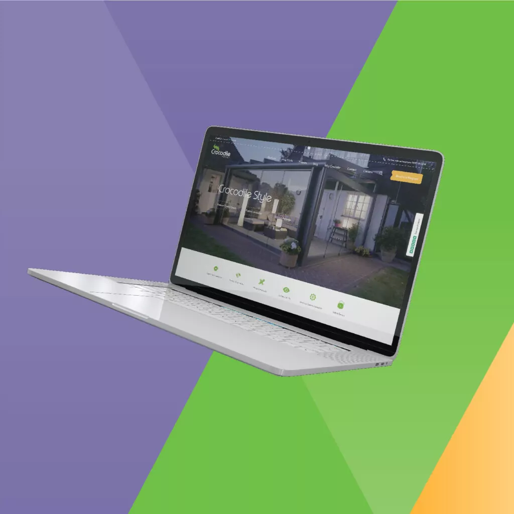A silver laptop displays a website showcasing a glass conservatory; it's against a vibrant green, purple, and orange background. The website headline reads, 